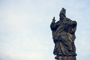 St. Adalbert statue on Charles Bridge in Prague, Czech Republic. Medieval Gothic bridge, finished in the 15th century, crossing the Vltava River