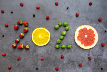 Wall Mural - New year 2020 made of fruit and berries on the concrete background.