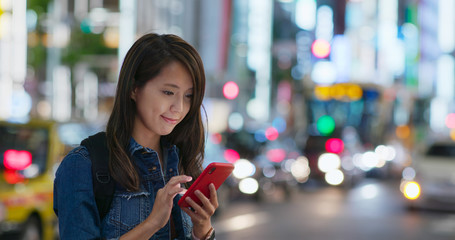 Poster - Woman use of mobile phone in Tokyo city at night