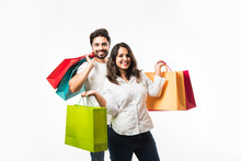 Indian Young Couple Shopping Bags, Standing Isolated Over White Background. Selective Focus