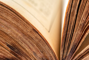 Close up of opened old book. Side view, shallow depth of field.