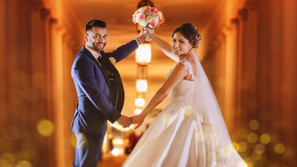 Happy bride and groom dancing