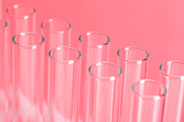 close up laboratory test tubes on red background