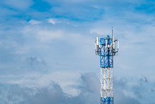 Telecommunication Tower With Blue Sky And White Clouds Background. Antenna On Blue Sky. Radio And Satellite Pole. Communication Technology. Telecommunication Industry. Mobile Or Telecom 4g Network.