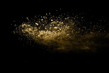 Wall Mural - golden powder explosion on black background. freeze motion.
