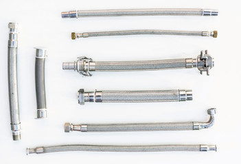 High pressure metal hoses of various formats and types on a white background, not insulated no isolated.