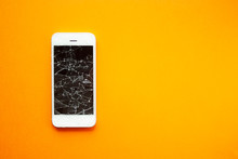 Broken Screen Of Smartphone On The Orange Background. Smashed Glass Of Cell Phone, Illustration For Repair, Fix Phone Services. Top View With Copyspace