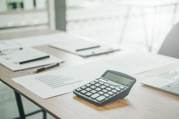 graph chart document calculator on accountant office desk table