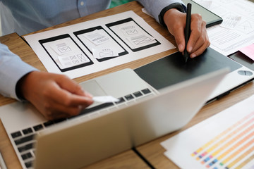 user experience UX designer designing web on smart phone layout. UI developer planning working on mobile application prototype