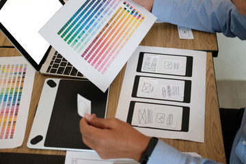 user experience UX designer designing web on smart phone layout. UI developer planning working on mobile application prototype
