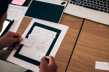 user experience ux designer designing web on smart phone layout. ui developer planning working on mo