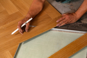 Wall Mural - Worker laying parquet flooring. Worker installing wooden laminate flooring