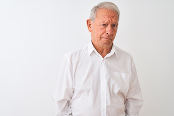 Poster - Senior grey-haired man wearing elegant shirt standing over isolated white background depressed and worry for distress, crying angry and afraid. Sad expression.