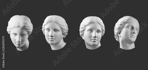 Fotomural Four gypsum copy of ancient statue Venus head isolated on black background