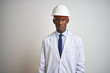© Krakenimages.com - African american engineer man wearing coat and helmet over isolated white background with serious expression on face. Simple and natural looking at the camera.