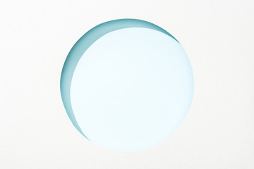 Sticker - cut out round hole in white paper on light blue background