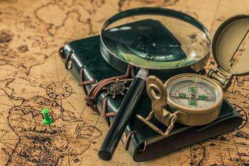 Aufkleber - old map with compass, notebook and magnifying glass.  The concept of searching for interesting places or treasures around the world.