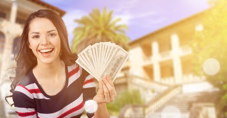 Wall Mural - Pretty young woman holding money banknotes on background