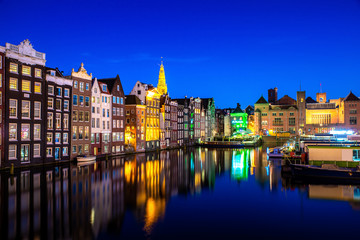 Wall Mural - Canals and tradition house in Amsterdam at night. Amsterdam is the capital and most populous city of the Netherlands.