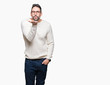 © Krakenimages.com - Young handsome man wearing glasses over isolated background looking at the camera blowing a kiss with hand on air being lovely and sexy. Love expression.