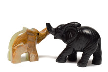 Figurines Of Elephants Play On A White Background