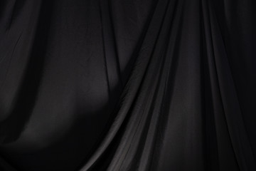 black curtain drape wave with studio lighting, wallpaper background texture detail