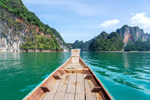 Limestone Mountains And Wooden Boat In Turquoise Lake
