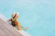 © siraphol - Portrait asian beautiful young woman happy smile relax around outdoor swimming pool in holiday vacation