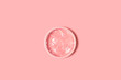 Menstrual disc isolated on pink background
