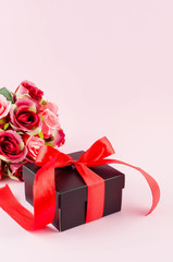 Wall Mural - gift box, roses and empty frame on a pink background