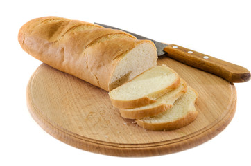 long loaf on a wooden board and knife isolated on a white background. Tasty Ukrainian bread