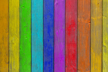 Close-up Of A   Rainbow Wooden  Wall  Or Fence Painted A Very Long Time And The Paint Peeled Off.  Fun Background For Kids Decor And Design.