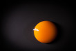 Egg yolk isolated on black background with space for copy