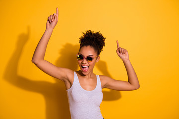 Close up photo beautiful nice pretty she her dark skin lady summer weekend rest relax dancing festive vacation fest modern moves motion wear sun specs casual tank-top isolated vivid yellow background