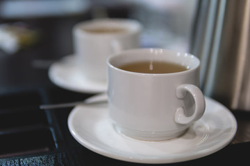 two white ceramic cups with tea