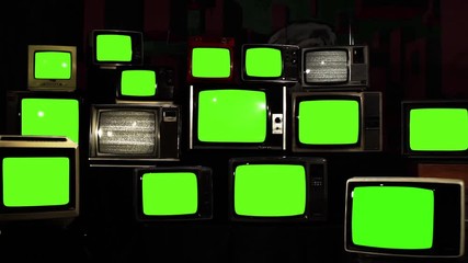 Wall Mural - stacked retro tvs turning on and off green screens. you can replace green screen with the footage or