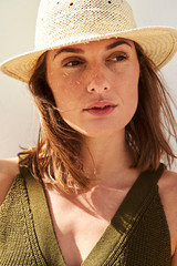 Wall Mural - Thoughtful and beautiful woman looking away in sunhat