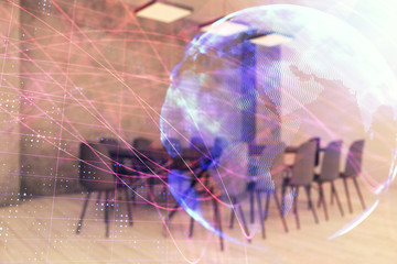 Double exposure of globe hologram on conference room background. Concept of international business