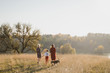 © anna_gorbenko - Samesex caucasian lesbian family with a child and a dog walking outdoors on the background of beautiful nature. Mothers having fun with their son.