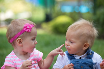 Wall Mural - Toddler children eating cake together, smashing in on themselves