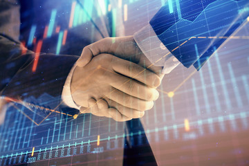 Multi exposure of forex graph on abstract background with two businessmen handshake. Concept of success on stock market