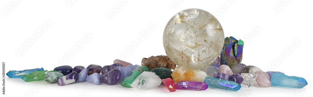 Row of multicoloured Healing Crystals Background Banner - Huge rutilated Crystal Ball surrounded by various tumbled healing stones and terminated quartz with space for copy - obrazy, fototapety, plakaty 