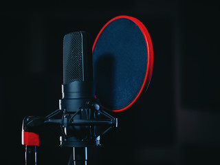 Microphone on black background in recording studio. Music, concert concept.