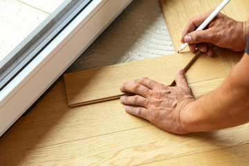 Wall Mural - Worker laying parquet flooring. Worker installing wooden laminate flooring