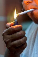 Man Lighting Up Cigarette