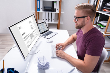 Poster - businessman checking invoice on computer