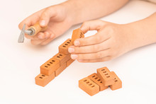 Construction Of Small Brick Blocks, Toy For Child Development On White Background.