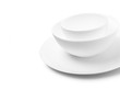 © SlayStorm - Set of white dishes on table on light background.