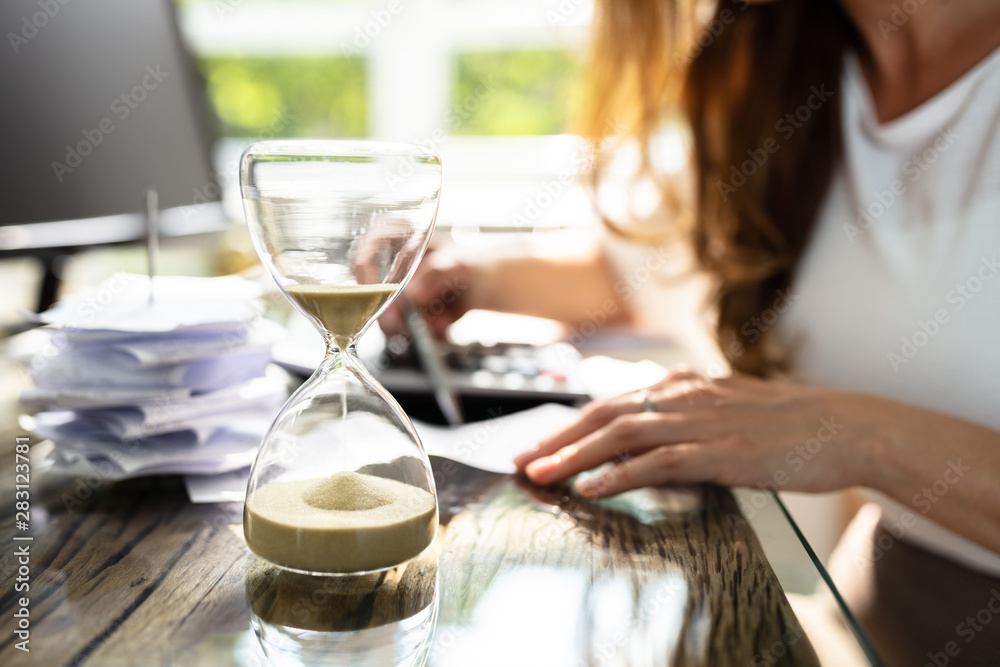 Close-up Of A Hourglass On Desk