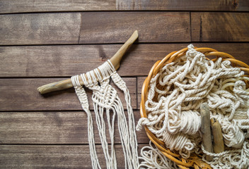 Weaving macrame. Favorite hobby.Weaving a natural cord on a branch